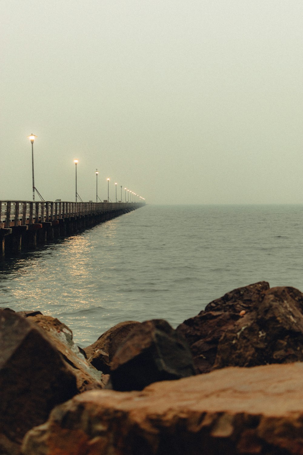 brown wooden dock on sea during daytime