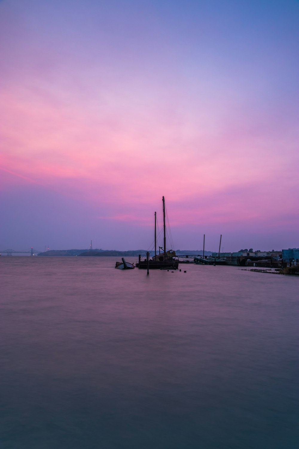 boat on sea under gray sky