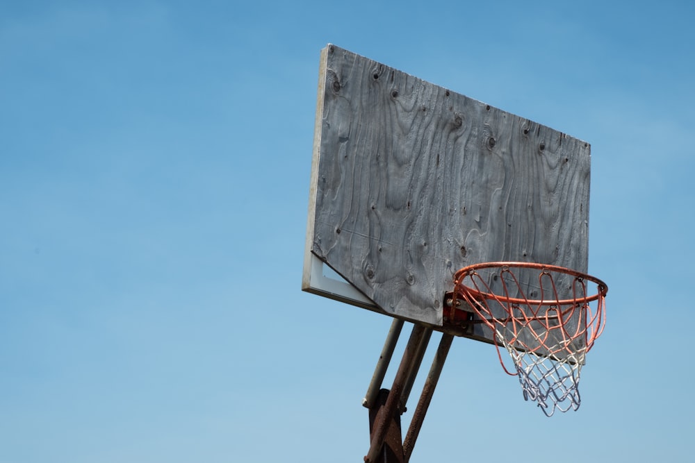 brown and white basketball hoop under blue sky during daytime