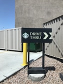 Drive-thru lane at a Dunkin' Donuts location with cars lined up for coffee.