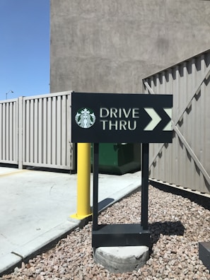 Drive-thru lane at a Dunkin' Donuts location with cars lined up for coffee.