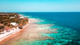 A scenic beach destination with turquoise waters and palm trees.