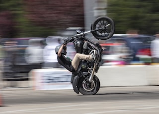 man in black jacket riding motorcycle