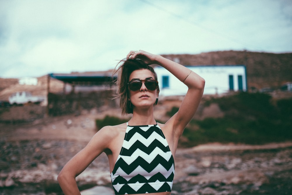 woman in black and white stripe tank top wearing black sunglasses