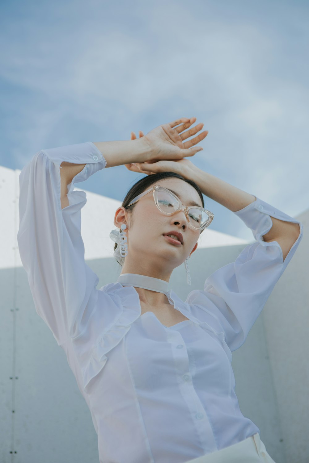 woman in white long sleeve shirt wearing black sunglasses