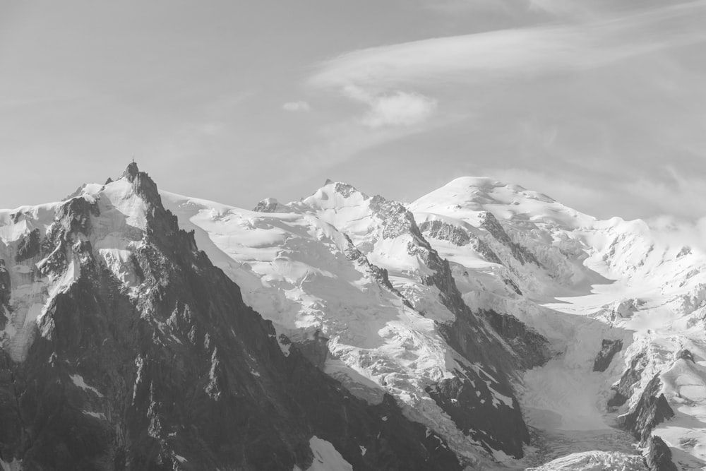 snow covered mountain under cloudy sky during daytime