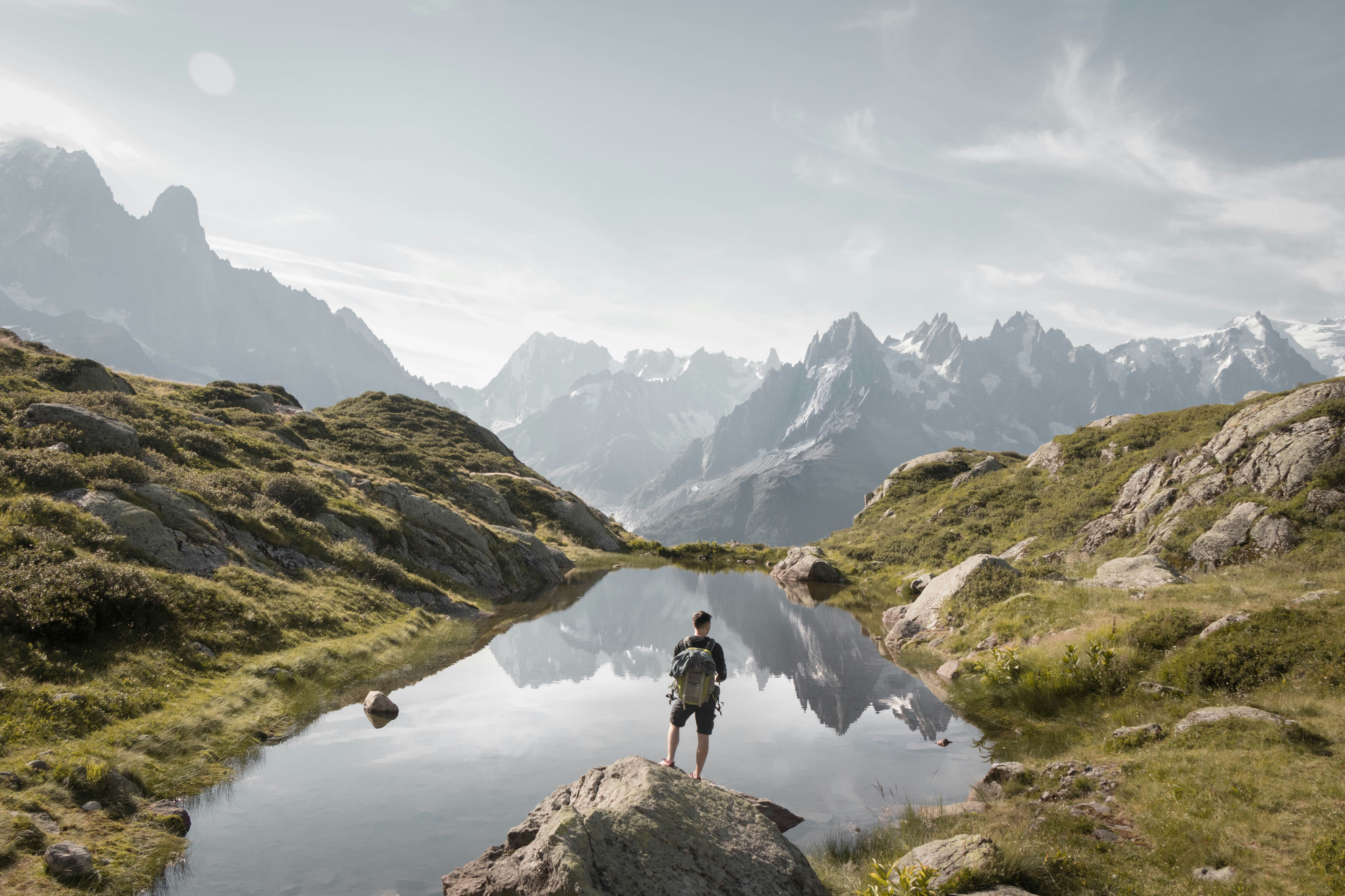 person standing on rock mountain during daytime, Hiking to Lac Blanc gives the best views ❤️</p><p>More on Instagram: @clem.i ✨