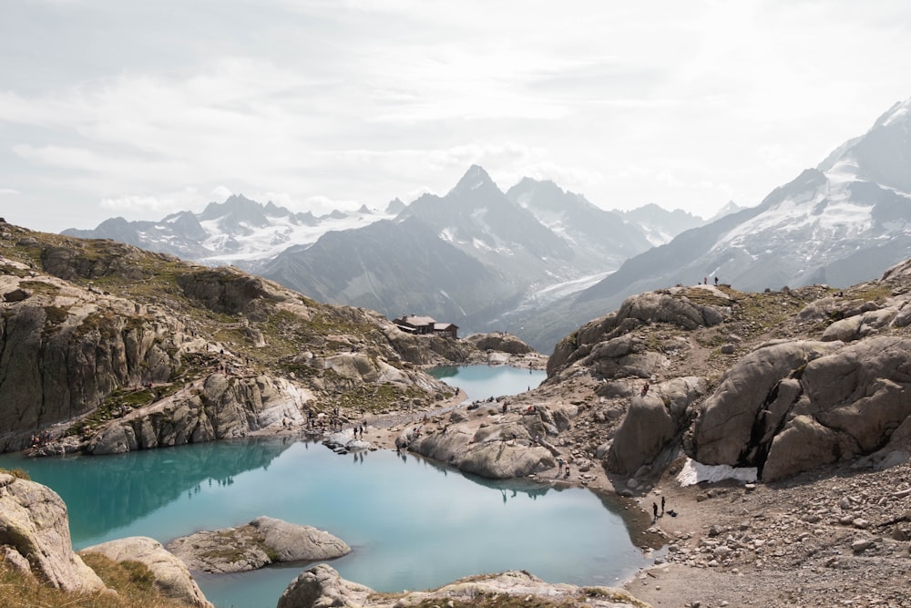 lake in the middle of mountains during daytime