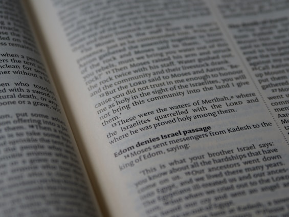 A close-up view of an open book displaying text in English, likely from a religious or historical context. The text appears to be formatted in paragraphs with some sections in bold, possibly indicating headings or significant passages.