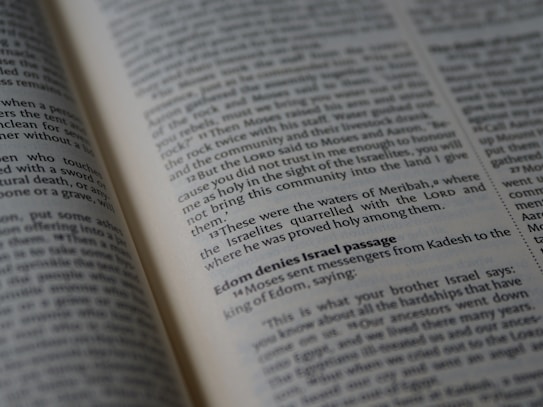 A close-up view of an open book displaying text in English, likely from a religious or historical context. The text appears to be formatted in paragraphs with some sections in bold, possibly indicating headings or significant passages.