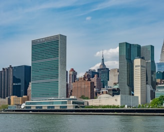 city buildings near body of water during daytime