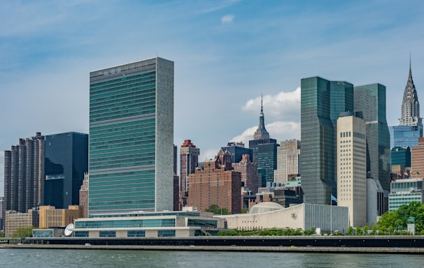 city buildings near body of water during daytime