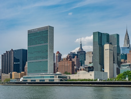 Film production services: city buildings near a body of water during the daytime