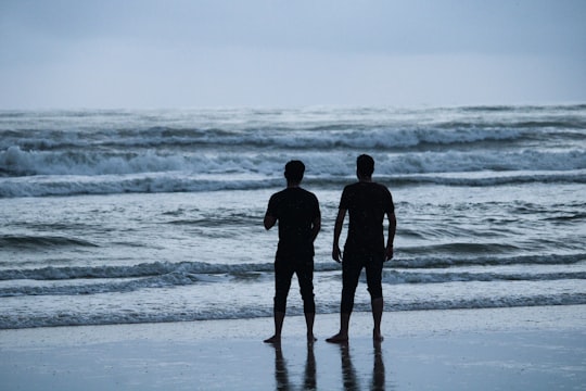 2 men standing on seashore during daytime in Udupi India
