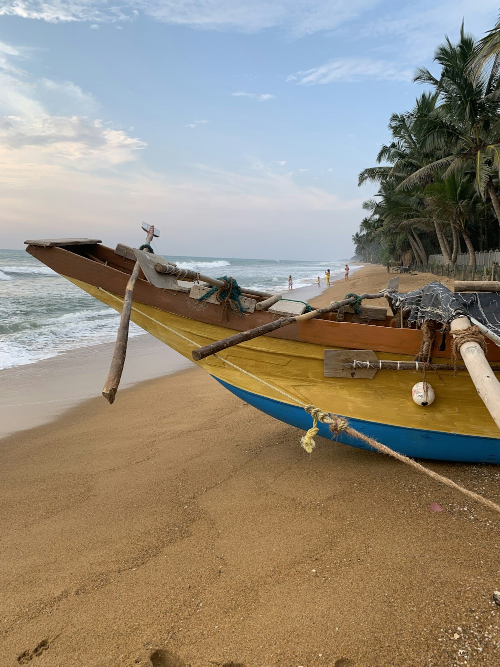 blue and brown boat on beach during daytime