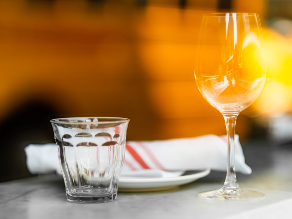 clear drinking glass with yellow liquid on table