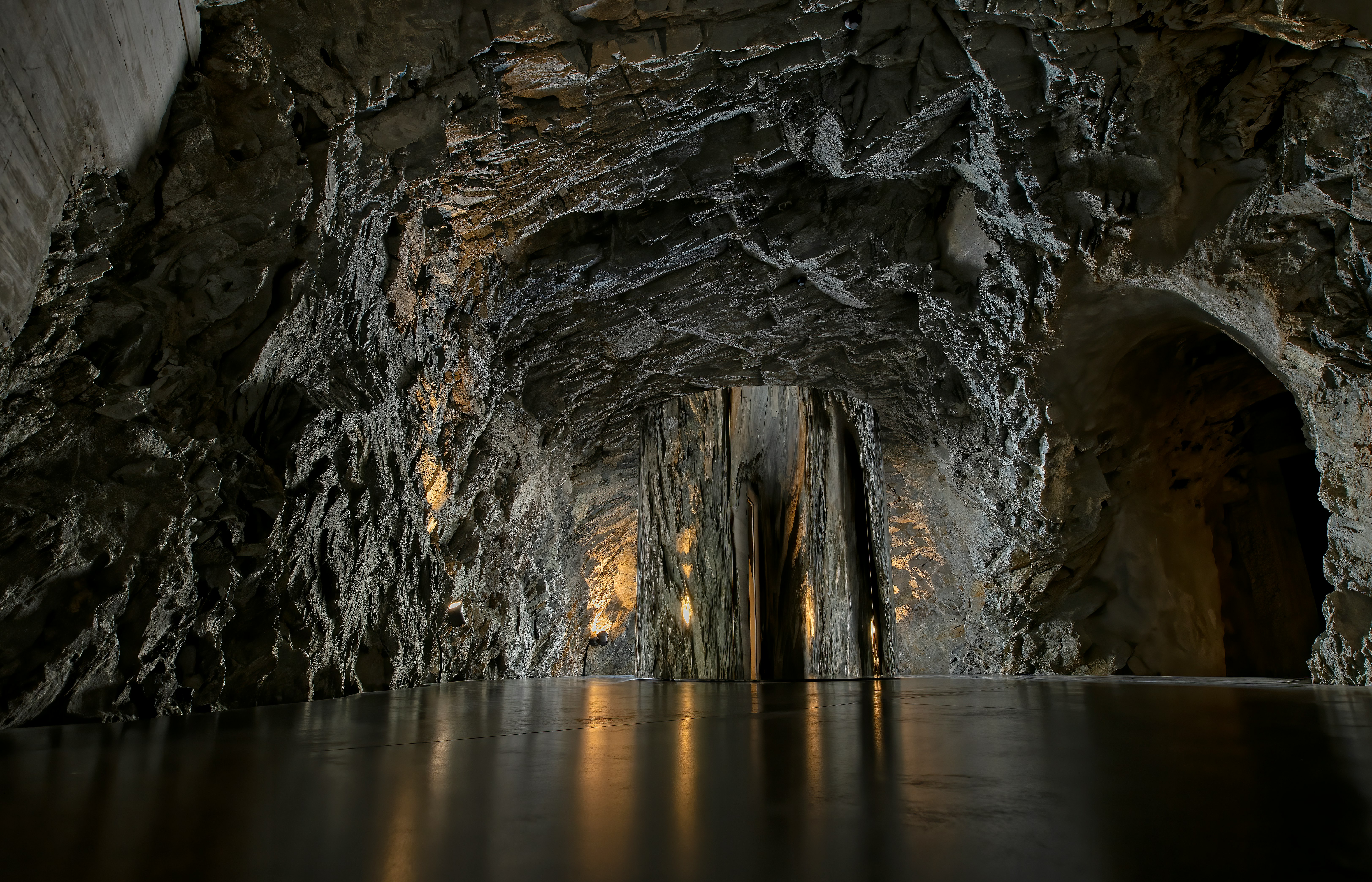 gray and black rock formation on body of water