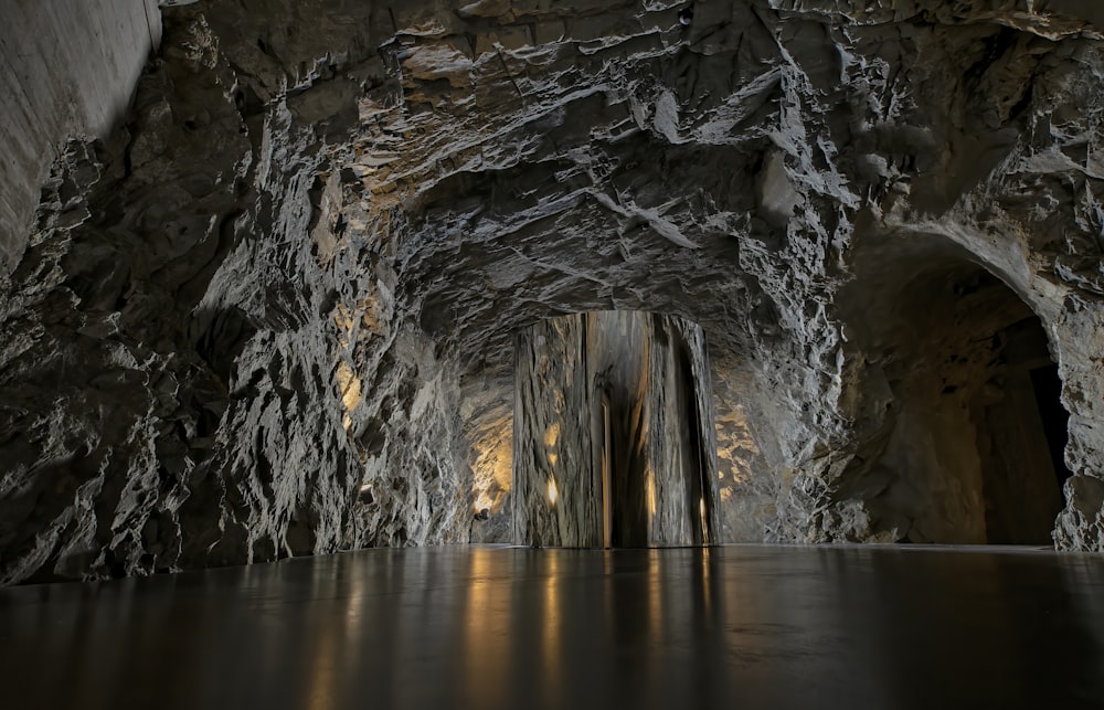 gray and black rock formation on body of water