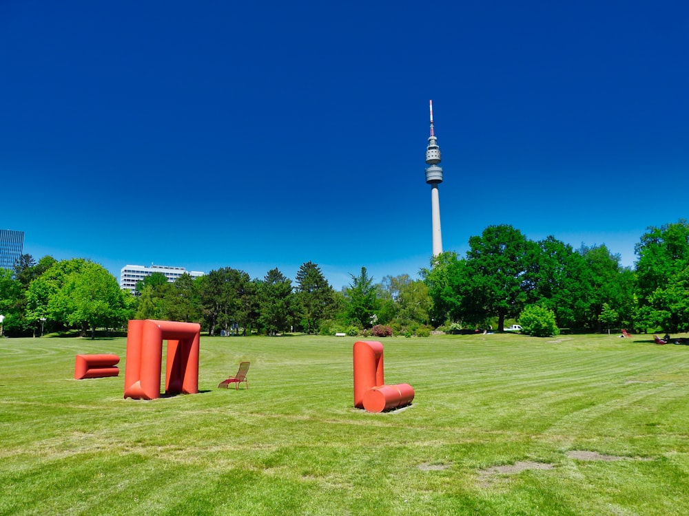 red and white outdoor post on green grass field during daytime