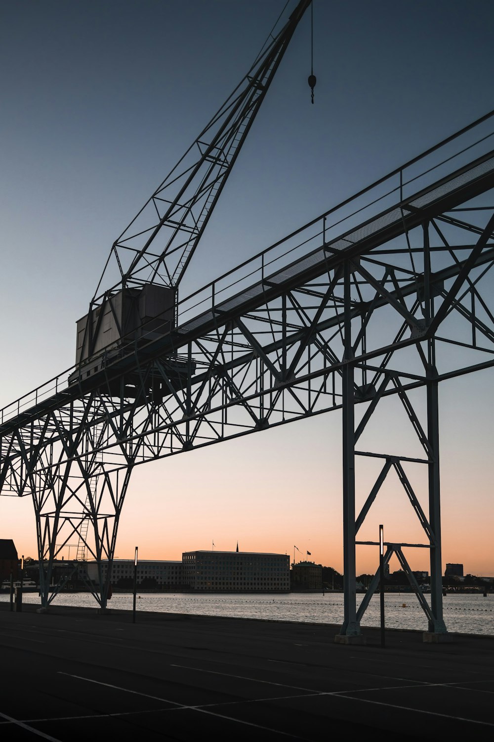 black metal crane under orange sky