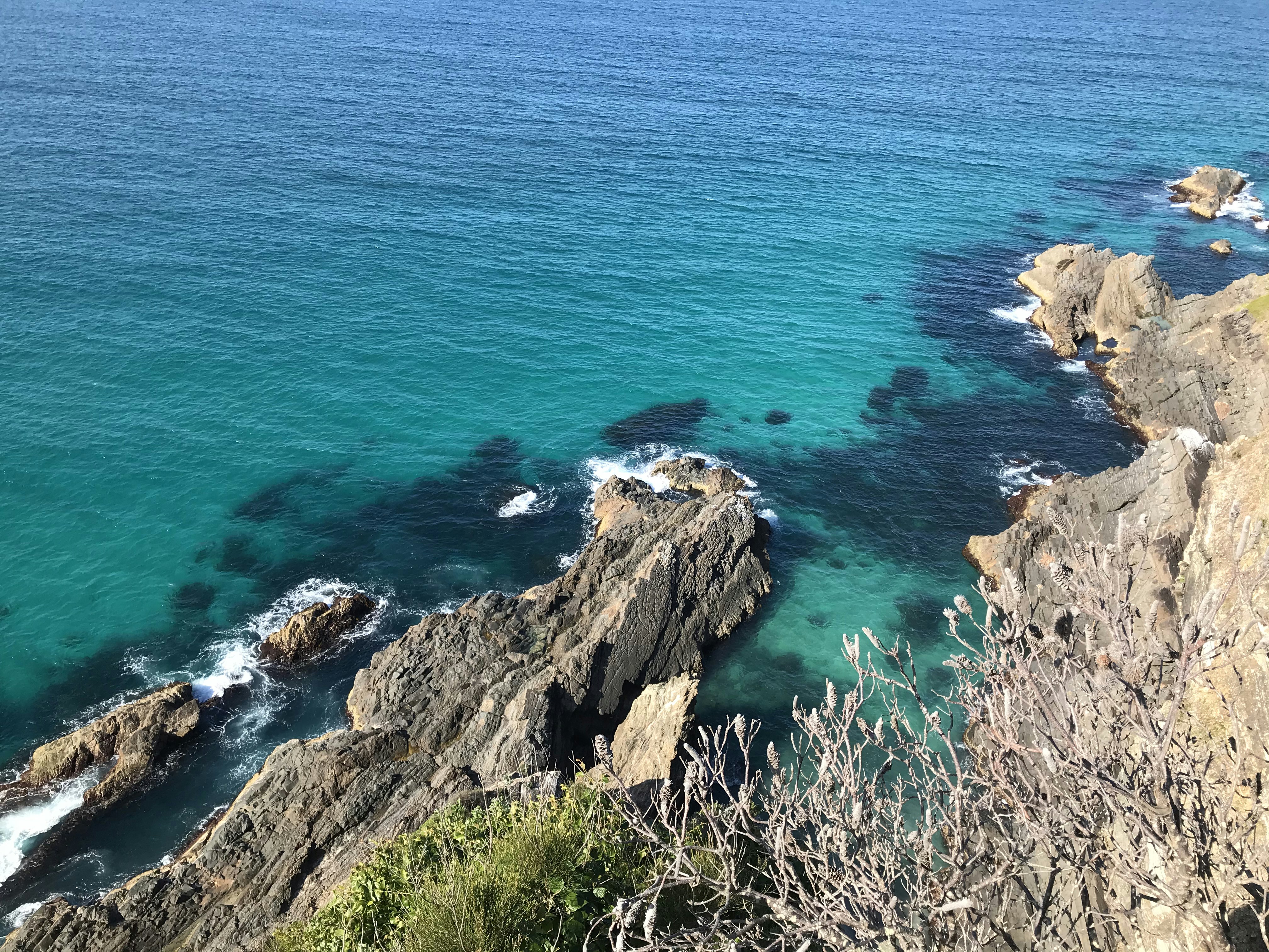 brown rock formation beside blue sea during daytime