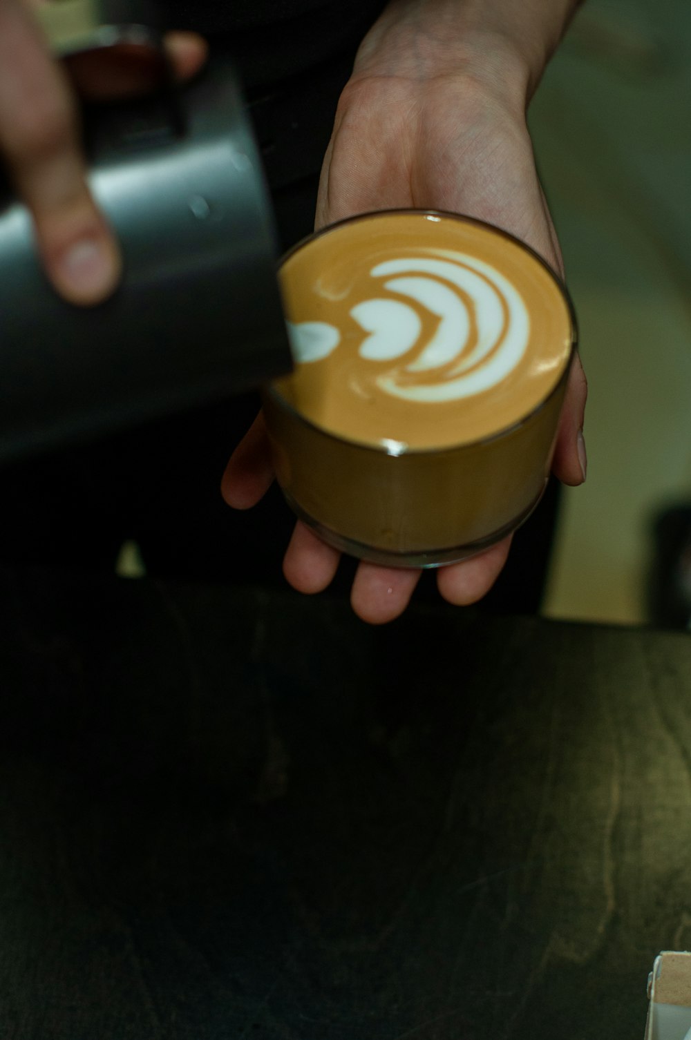 person holding brown plastic cup