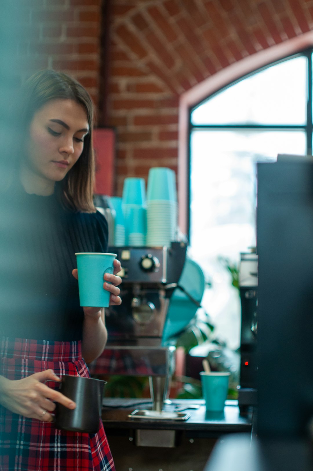 woman in gray crew neck shirt holding blue ceramic mug