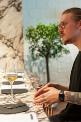 Person wearing smart glasses using real-time AI translation during a conversation in a café.