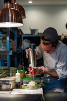 A chef preparing a traditional dish in a bustling kitchen.