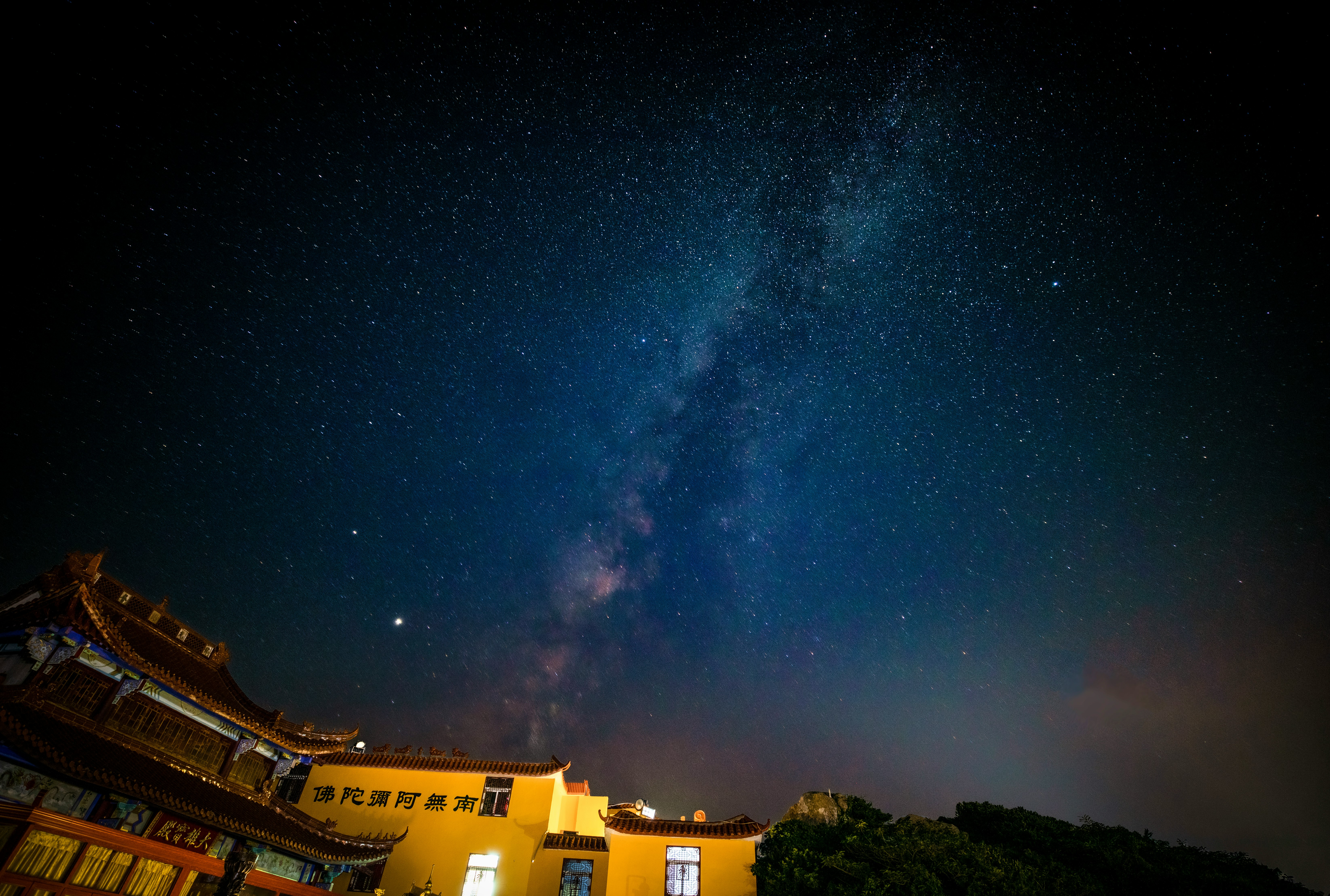 brown concrete building under blue sky during night time