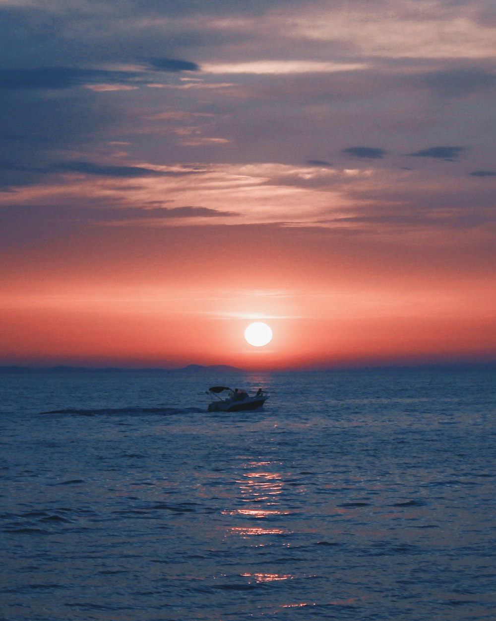 boat on sea during sunset