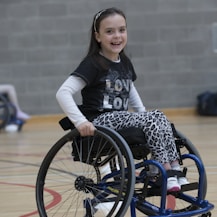 girl in black and white long sleeve shirt sitting on black wheelchair