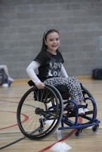 girl in black and white long sleeve shirt sitting on black wheelchair