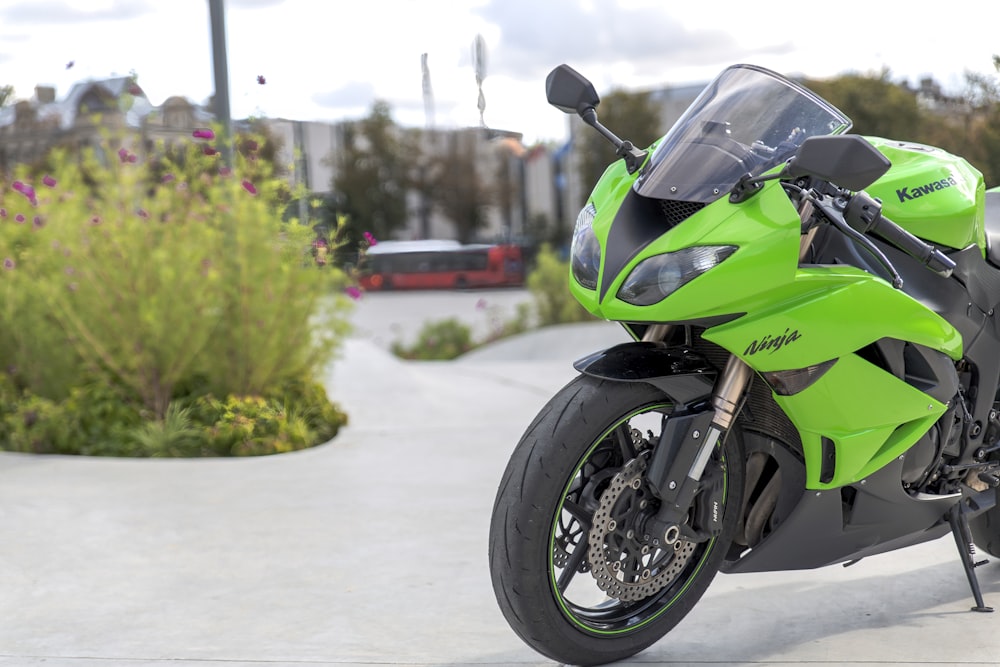 green and black sports bike on road during daytime