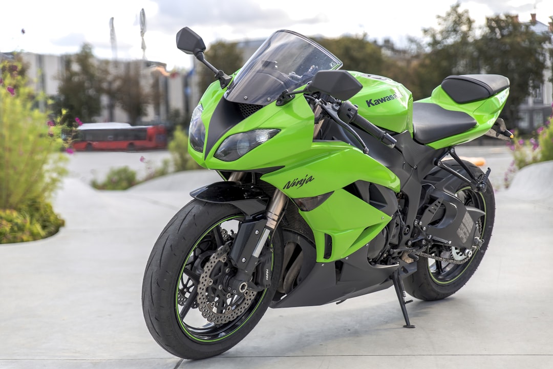 green and black sports bike,