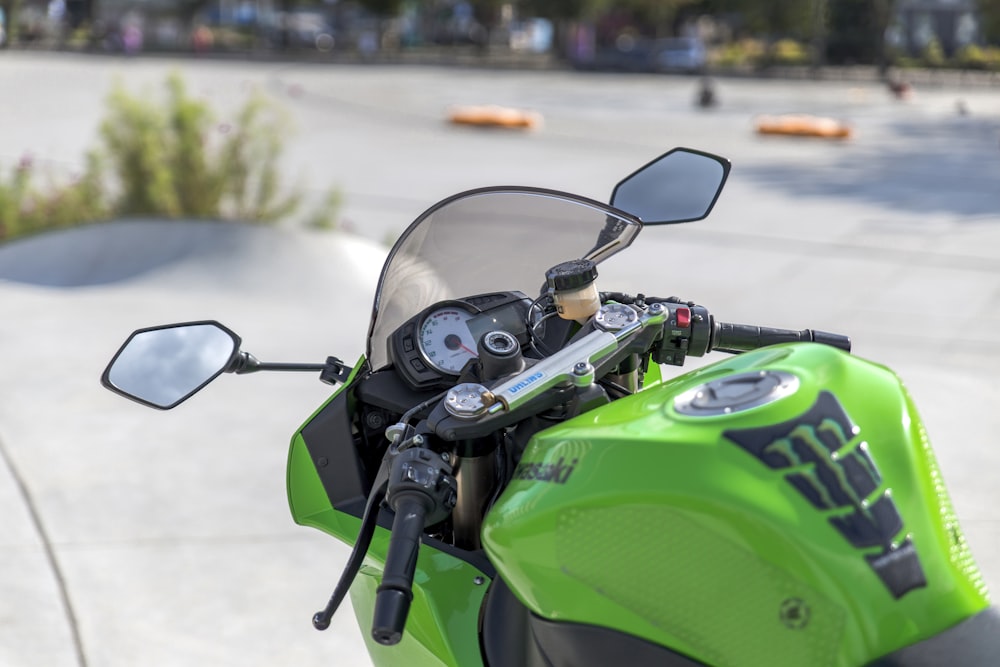 green and black motorcycle in tilt shift lens