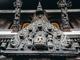 A beautifully carved wooden mandir with intricate detailing and a smooth finish.