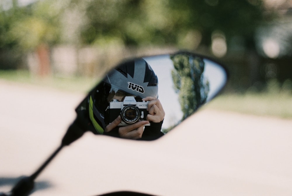 person holding black and green nikon dslr camera