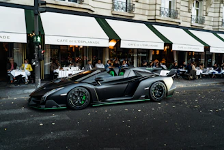 A sleek car pulling up to evlo coffee company’s drive-thru window with a friendly barista ready to serve.