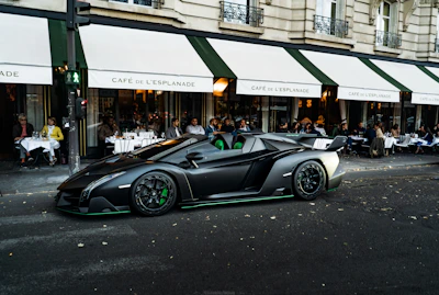 A sleek car pulling up to evlo coffee company’s drive-thru window with a friendly barista ready to serve.