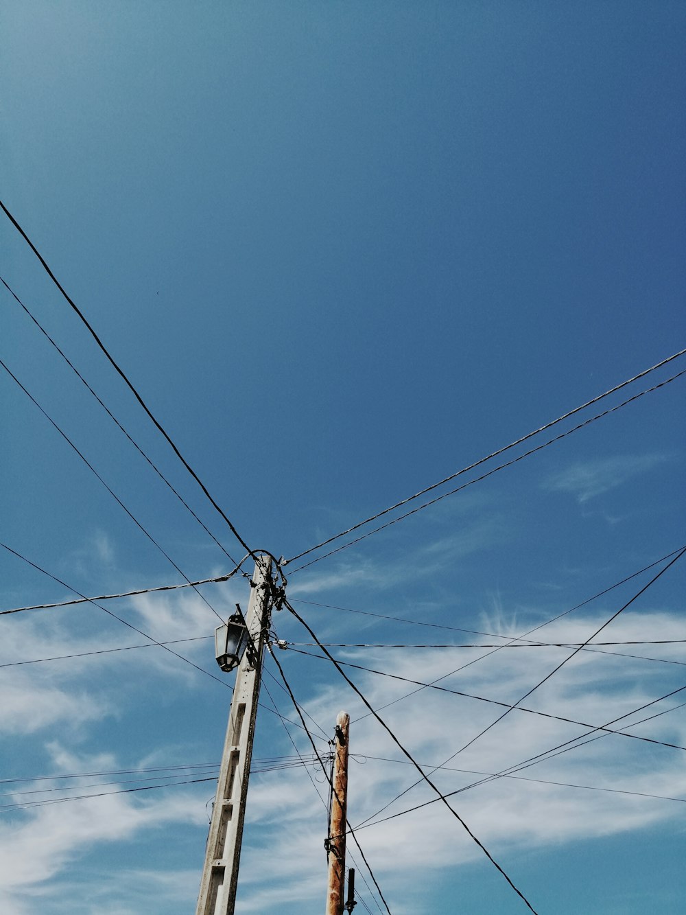 black electric post under blue sky during daytime