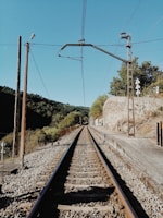 brown metal train rail during daytime