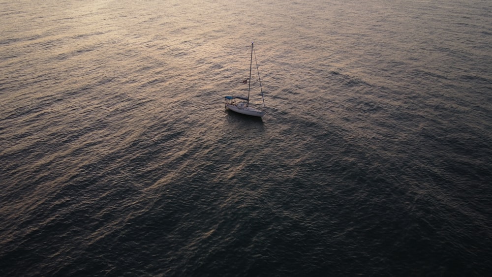 white boat on body of water during daytime