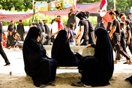 people sitting on brown concrete floor during daytime