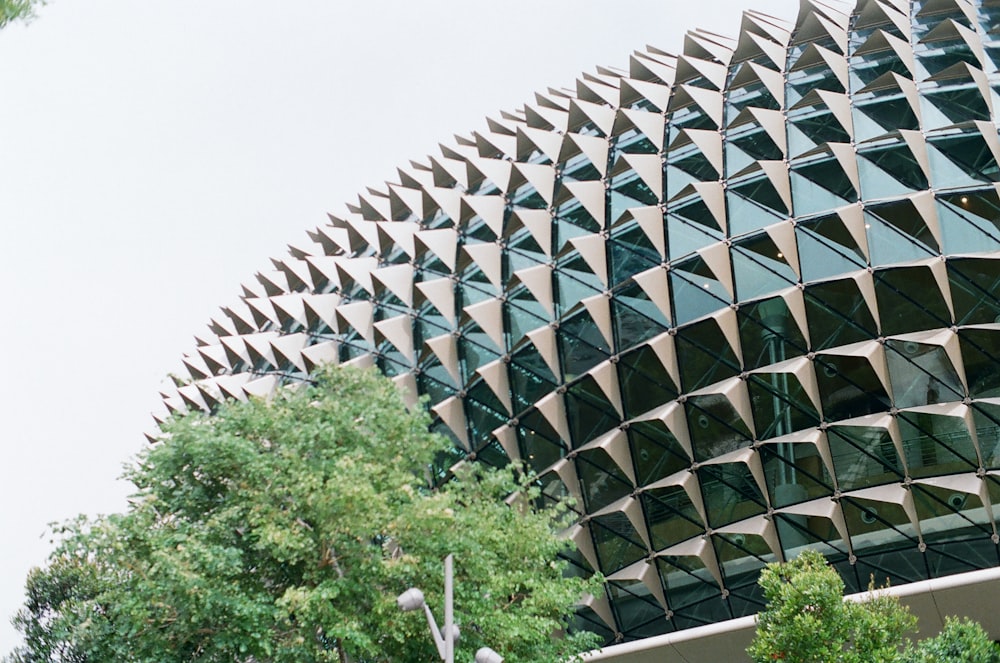 gray concrete building near green trees during daytime