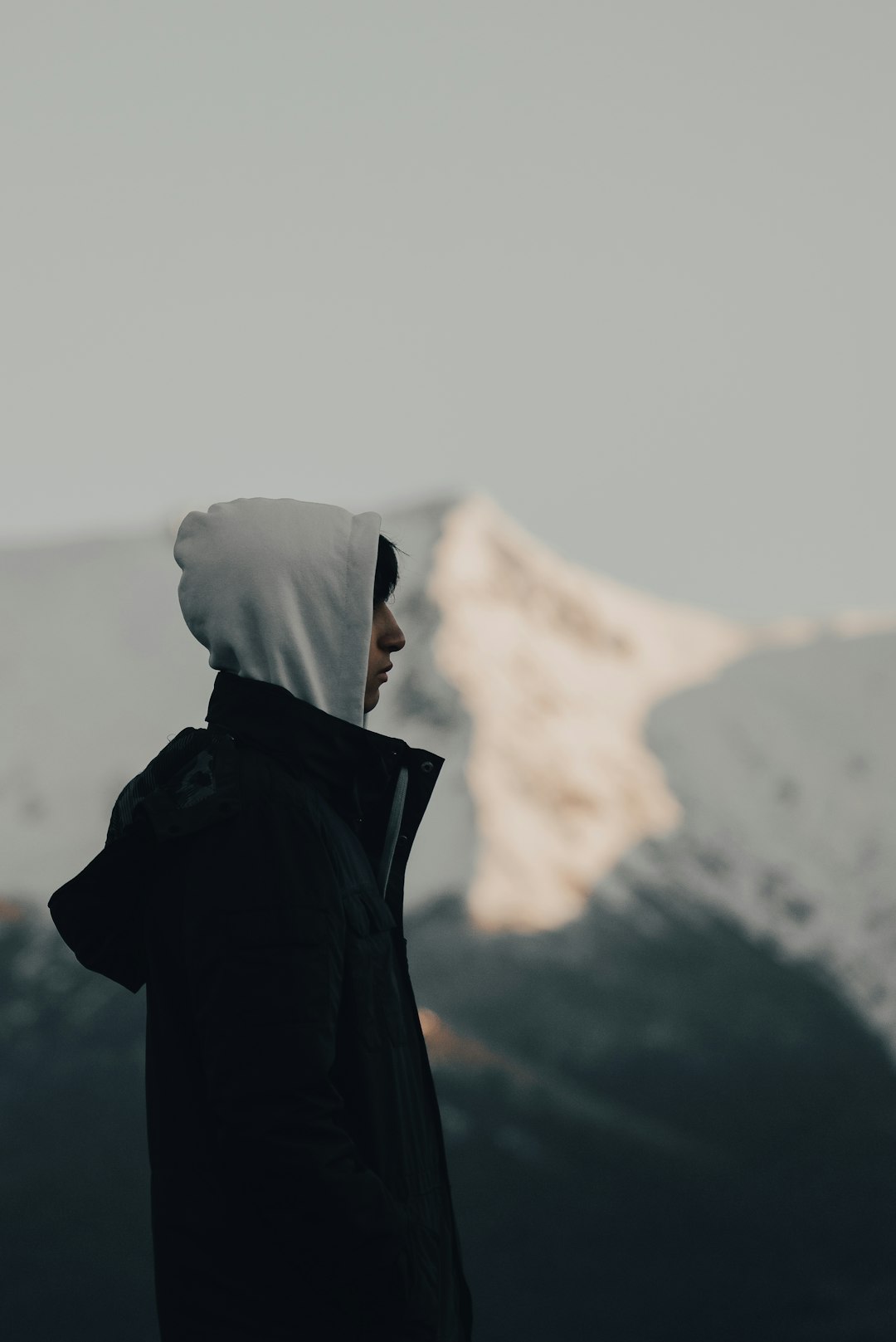 person in black coat standing on top of mountain during daytime