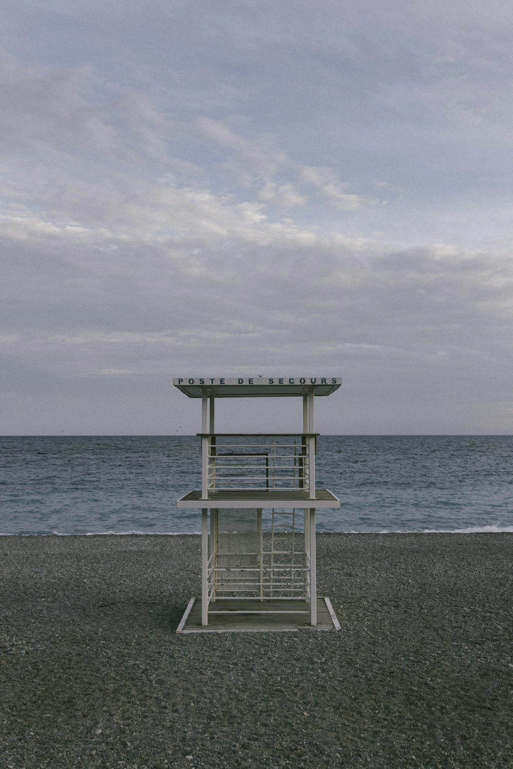 white wooden lifeguard chair on beach during daytime