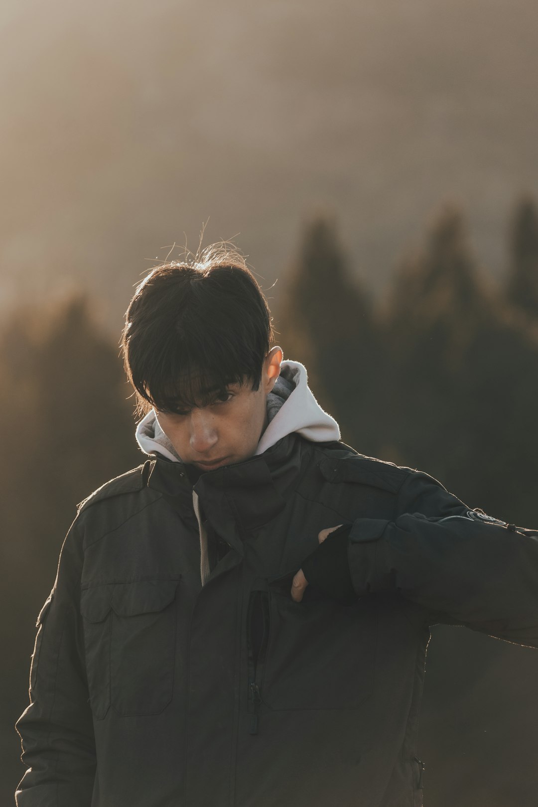 boy in black jacket standing