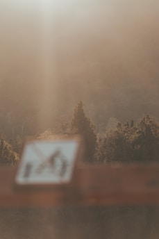 A softly blurred construction sign with gentle morning light casting warm shadows.