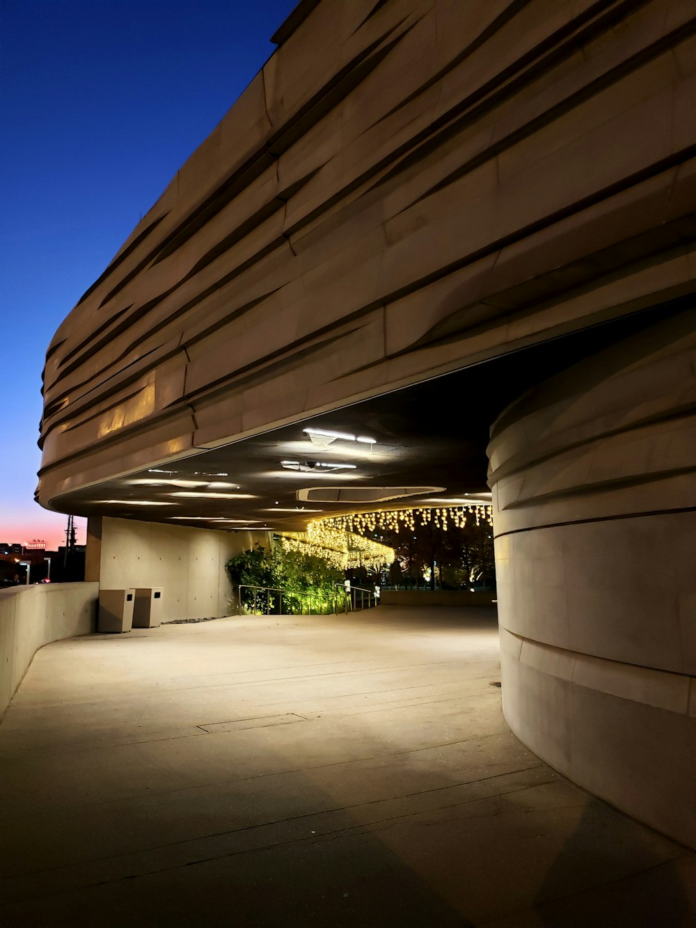 white concrete building with lights turned on during night time